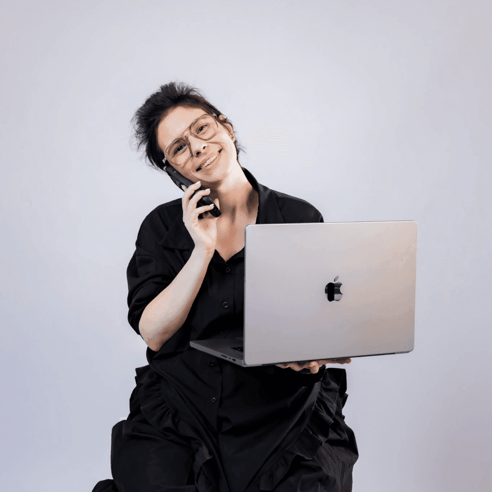 Anastasia telefonira držeći laptop
